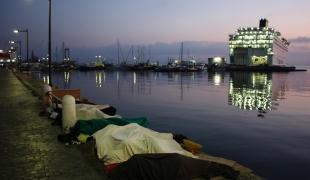 A l'aube des réfugiés dorment à même le sol dans le port de Kos.