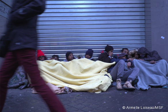 Des migrants blottis sous des couvertures près de la Halle Pajol, dans le 18ème arrondissement de Paris, le 10 janvier 2017.