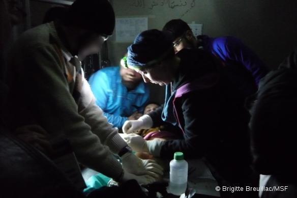 Un médecin de MSF soigne un garçon grièvement brûlé dans un poste médical avancé, en Syrie.