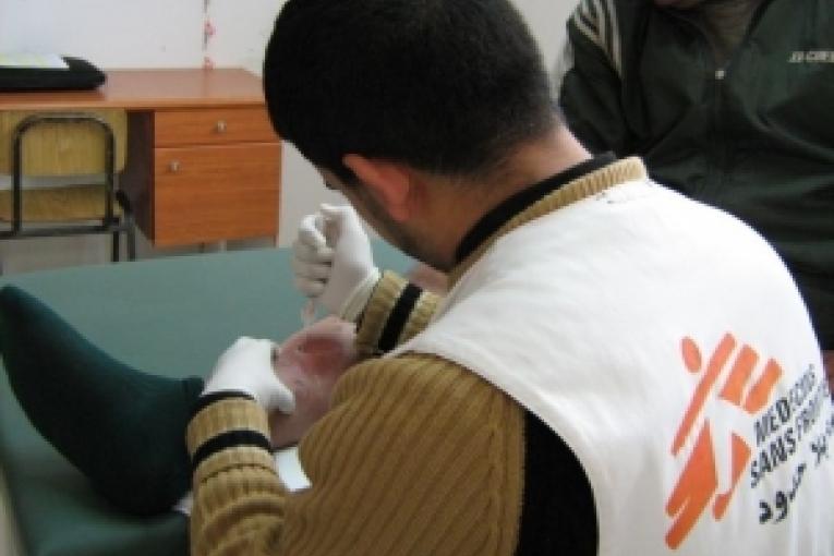 Dans la clinique MSF de Khan Younis dans le sud de la bande de Gaza un infirmier nettoie une plaie infectée.
