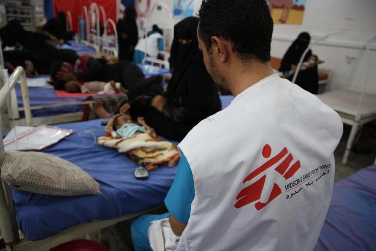 Un membre des équipes MSF de l'hôpital d'Abs, auprès d'un enfant âgé de 3 mois souffrant de malnutrition. Yémen. 2020.