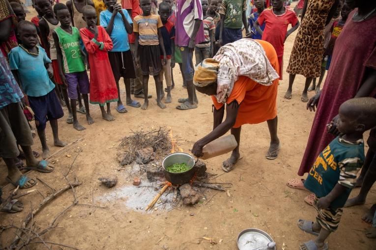 Une femme cuisine des feuilles d'arbres pour tenter de subvenir aux besoins de ses cinq enfants. Soudan du Sud. 2022.