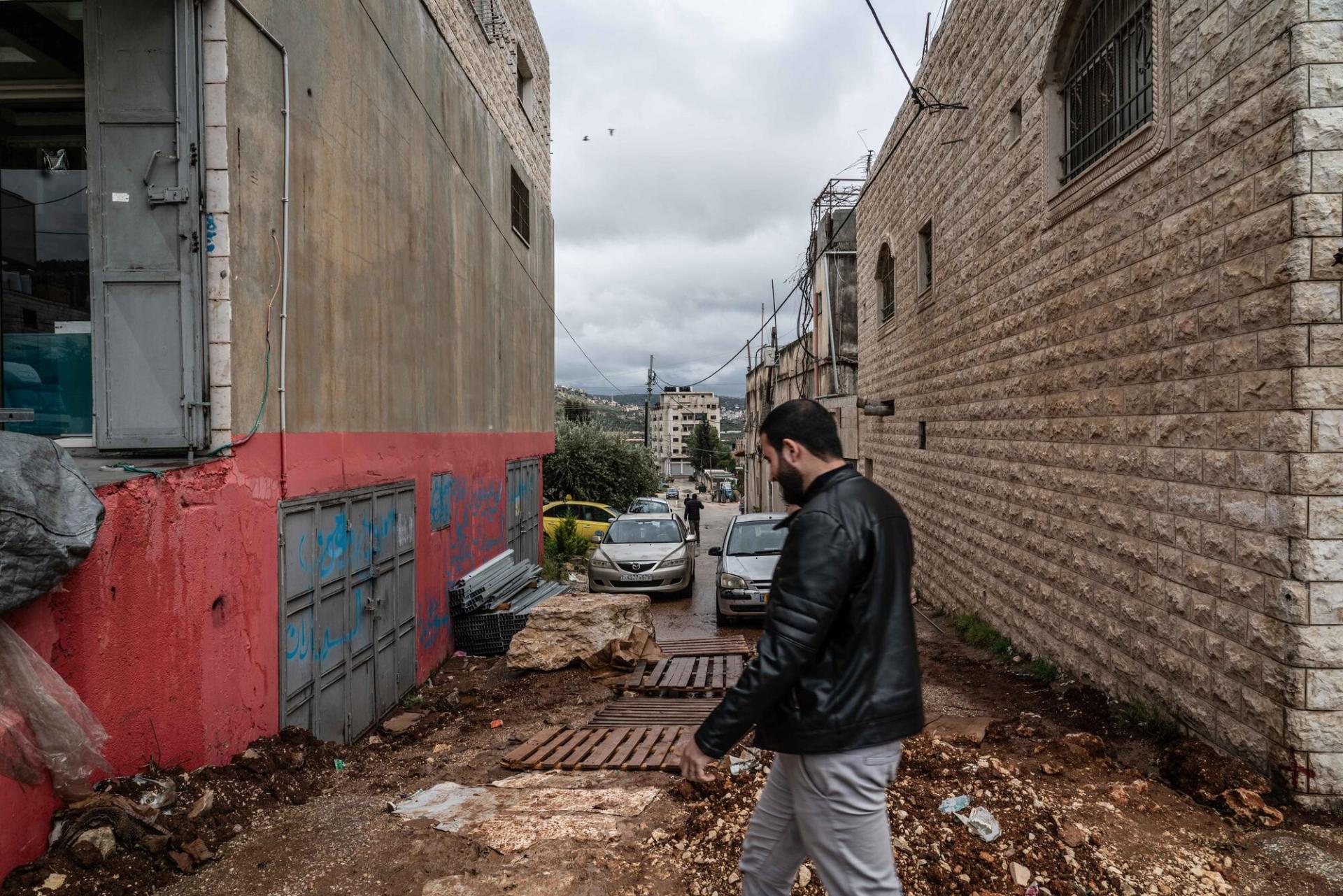 Un Palestinien marche aux abords d'une rue bloquée par les forces israéliennes à Huwara. Avril 2023.