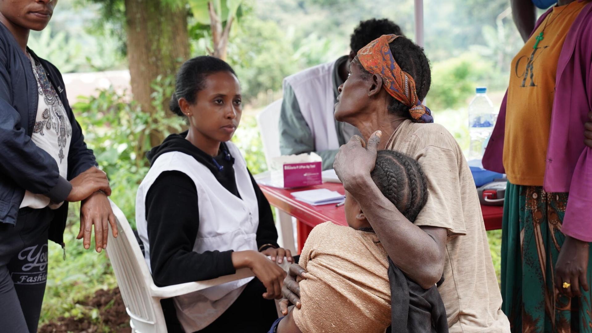 MSF outreach team attending a mother and her child during the screening.