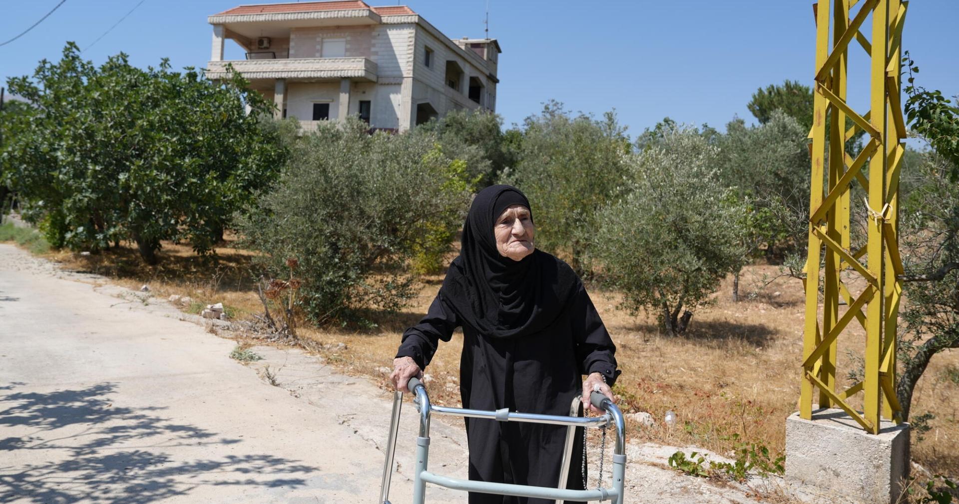 Zahra Ali stands outside her home in Yohmor after being displaced