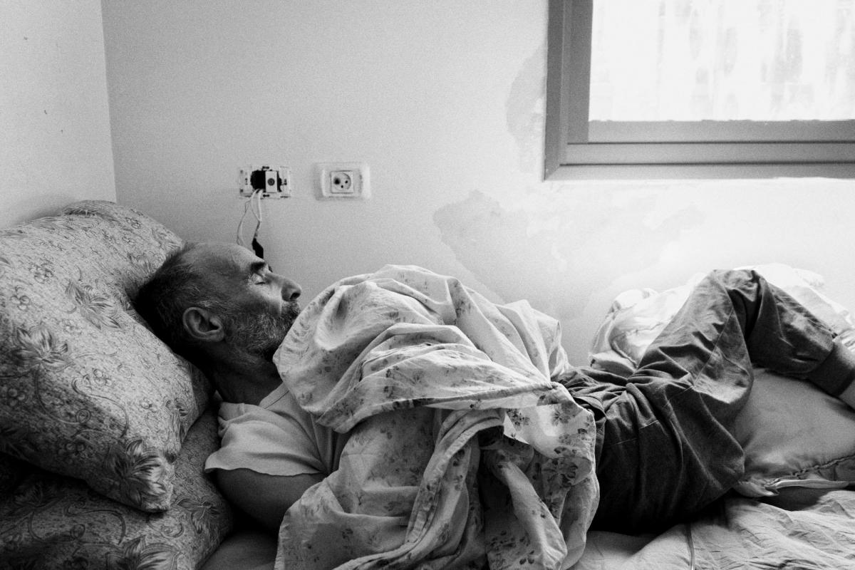 Mahmoud est un Palestinien de 74 ans qui souffre de troubles cognitifs dus à un accident vasculaire cérébral. Il a par la suite été frappé par des soldats israéliens à un check-point. Il est désormais alité et pris en charge par sa femme. Palestine. 2018.
 © Moises Saman/Magnum Photos