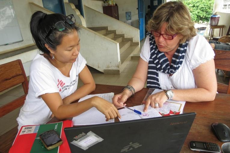 HR Coordinator Isabelle and Donka's Field Admin centre Marie go through a batch of applications, looking for an administrative assistant for the Ebola mission. Guinea. 2014.
 © Laura Bianchi/MSF