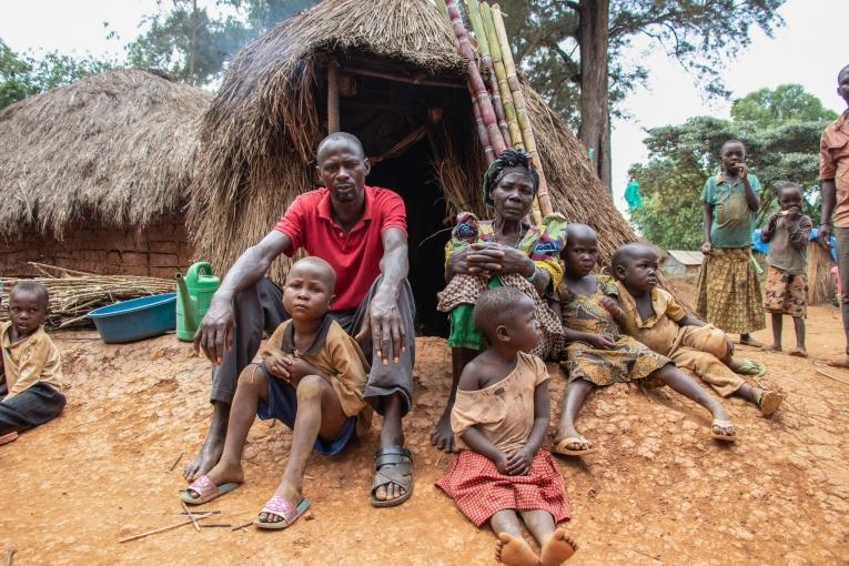 Yvonne, son fils et ses six petits-enfants devant leur cabane de paille dans le camp de Tse Lowi, dans la zone de santé de Nizi.
 © MSF/Solen Mourlon