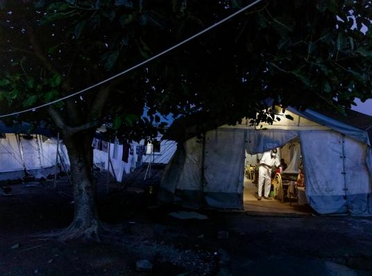 Un membre du personnel médical de MSF soigne un patient dans l'une des tentes antipaludiques installées dans la cour de l'hôpital d'État d'Aweil. Octobre 2021.