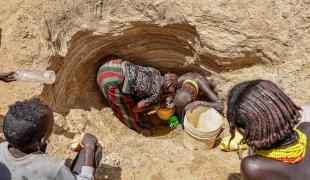 Des femmes cherchent de l'eau dans l'un des puits peu profonds situés le long d'un lit de rivière asséché à Illeret. La sécheresse ravageuse a entraîné une pénurie d'eau dans la région, obligeant les habitants à chercher des sources d'eau alternatives, impropres à la consommation humaine.