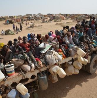 Displaced civilians from El Fasher on a truck