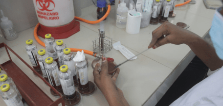 A bacteriology laboratory technician at CSREF Koutiala, Mali, seeds cultures.